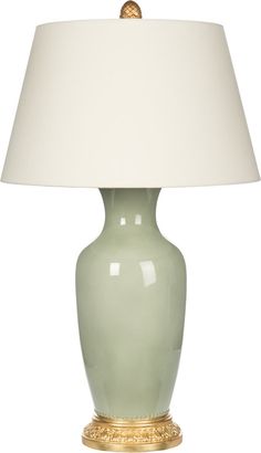 a light green lamp with a white shade on the top and gold trimmings