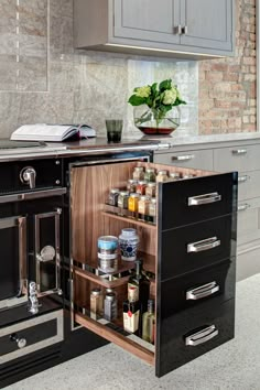 an open cabinet in the middle of a kitchen