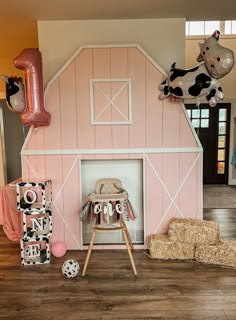 a baby's room decorated in pink, white and black with farm animals on the wall