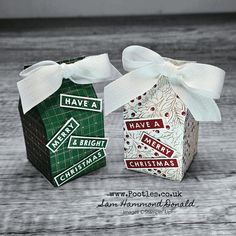 two small boxes with bows on them sitting next to each other