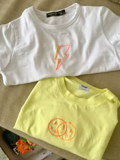 two children's t - shirts with embrown faces and lightning bolt on them