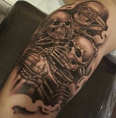 a man with a tattoo on his arm has two skulls in the shape of skeletons