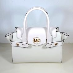 Carmen Medium Faux Leather Belted Satchel Optic White Satchel Faux Leather 88.92% Coated Canvas/11.08% Polyester Gold-Tone Hardware 11"W X 7.75"H X 5"D Handle Drop: 4.75” Exterior Details: Detachable Crossbody Strap Interior Details: Back And Front Slip Pockets Lining: 100% Polyester Push-Lock Fastening Janet Guzman, Exterior Details, Faux Leather Belts, Leather Satchel, Crossbody Strap, Michael Kors Bag, Interior Details, Satchel, Michael Kors