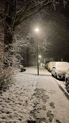 two cars parked in the snow at night