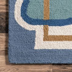 a blue and white rug on top of a wooden floor