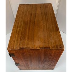 an old wooden box sitting on top of a white table