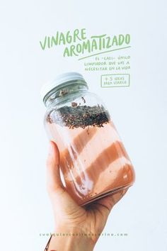 a hand holding a jar filled with food on top of a white background and the words vinagre, aromaatizado written above it