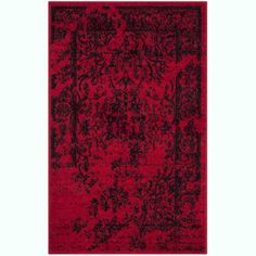 a red rug with black and grey designs on it