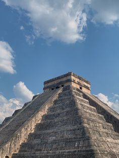 an image of a pyramid in the middle of the day with clouds above it and blue sky