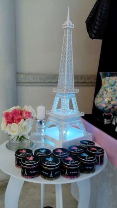 the eiffel tower is lit up with lights and candy in front of it