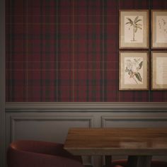 a table and chairs in a room with plaid wallpaper on the walls behind them