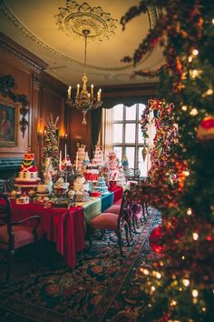 a dining room decorated for christmas with lots of food