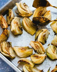 roasted artichokes on a baking sheet ready to be cooked