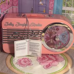 a pink radio sitting on top of a table