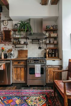 a kitchen with an oven, dishwasher and rug