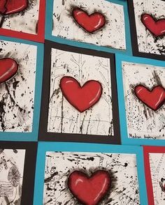 some red hearts are placed on white and blue paper with black border around the edges