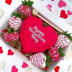 a valentine's day box with strawberries and chocolates in the shape of a heart