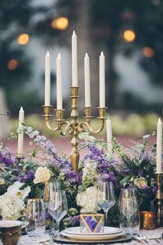 a table with candles and flowers on it