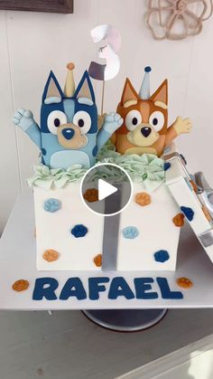 an image of a cake with cartoon characters on the top and bottom layer that says rafal