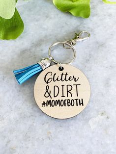 a wooden keychain that says,'better and dirt momboth '