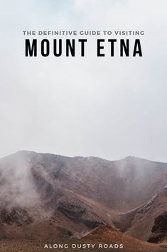 mountains with the words mount etna in black and white above them, on a cloudy day