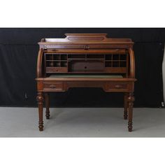 an old wooden desk with drawers on it