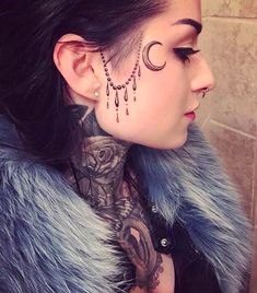 a woman with tattoos on her face and neck