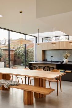 an open kitchen and dining room with large windows