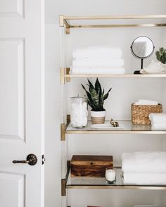 a bathroom with shelving and toiletries in it