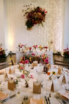 the table is set with flowers and place settings