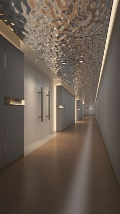 an empty hallway with white walls and wood flooring is lit by sunlight coming through the ceiling