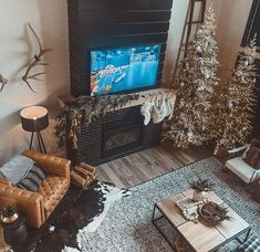 a living room filled with furniture and a flat screen tv mounted on the wall above a fire place