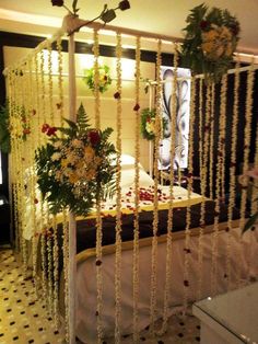 the bed is decorated with flowers and beads