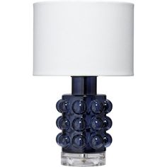 a blue glass table lamp with a white shade on the top and bottom part of it