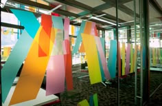 an office building with glass walls and colorful artwork