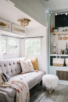 a living room filled with furniture and a flat screen tv mounted to the side of a wall