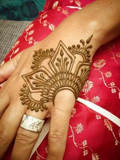 a woman's hand with henna on it