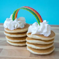 some pancakes with whipped cream and a rainbow on top