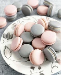 a white plate topped with pink and grey macaroons