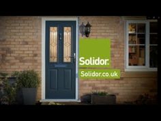 a blue door with the words soldor on it in front of a brick building