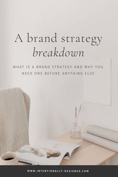 a desk with a book and cup on it next to a wall that says, a brand strategy breakdown what is a brand strategy and why you need one before anything else