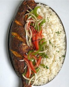 a plate with rice, meat and vegetables on it