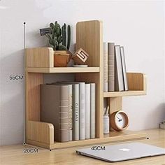 a wooden book shelf with books on it and a laptop next to it, measurements