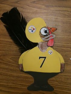 a paper cut out of a duck with a number seven on it's chest