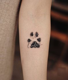 a dog paw print on the right arm and leg, with black ink in it