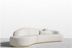 a white couch sitting on top of a white floor