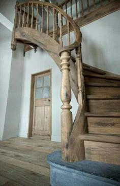 an old wooden spiral staircase in a house