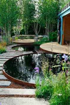 an outdoor garden with water and stepping stones