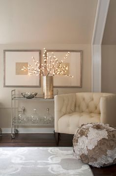 a living room filled with furniture and a chandelier hanging over the top of it