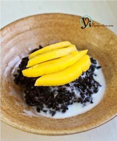 a bowl filled with rice and mango slices